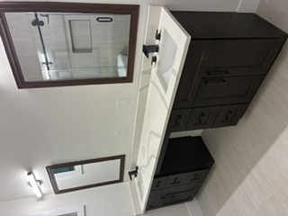 Bespoke walnut library with integrated LED lighting and floor to ceiling shelves