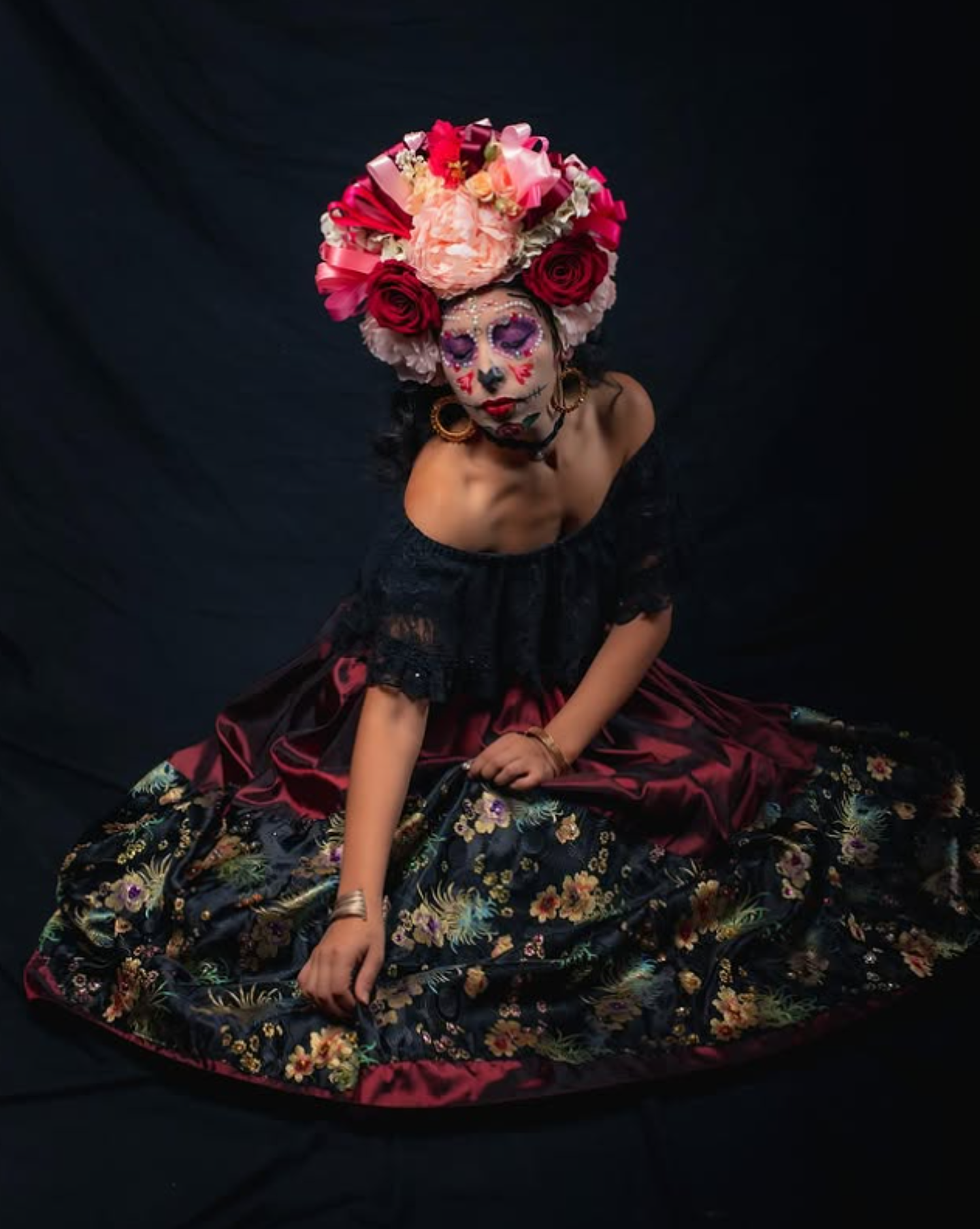 Folklorico dancer showcasing a premium custom floral hairpiece and ornate earrings