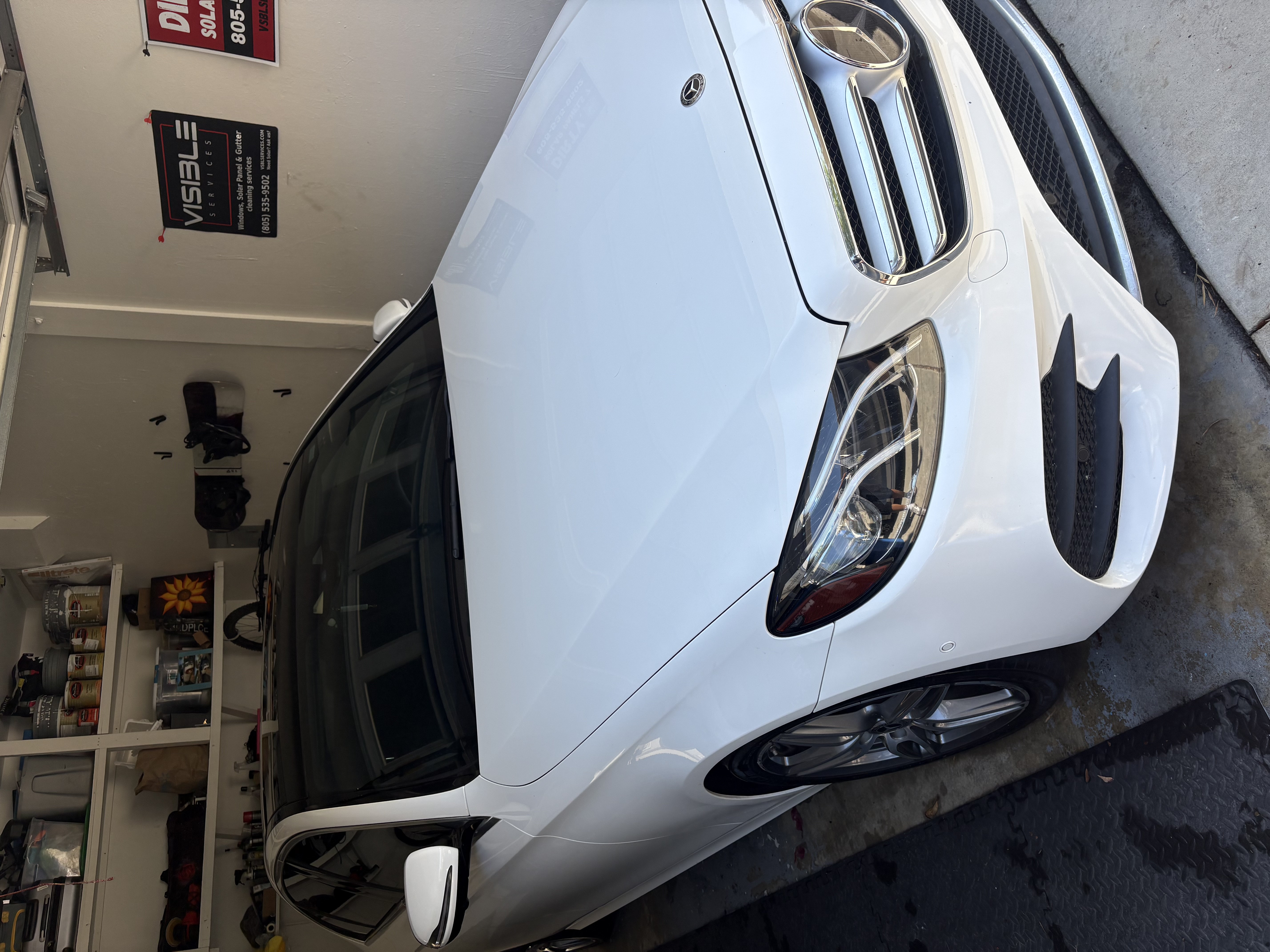 Glistening water beading on a freshly detailed red luxury sedan hood
