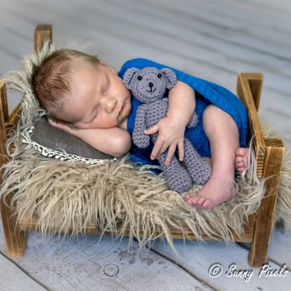 Close-up of a peaceful sleeping newborn baby wrapped in a soft, textured blanket