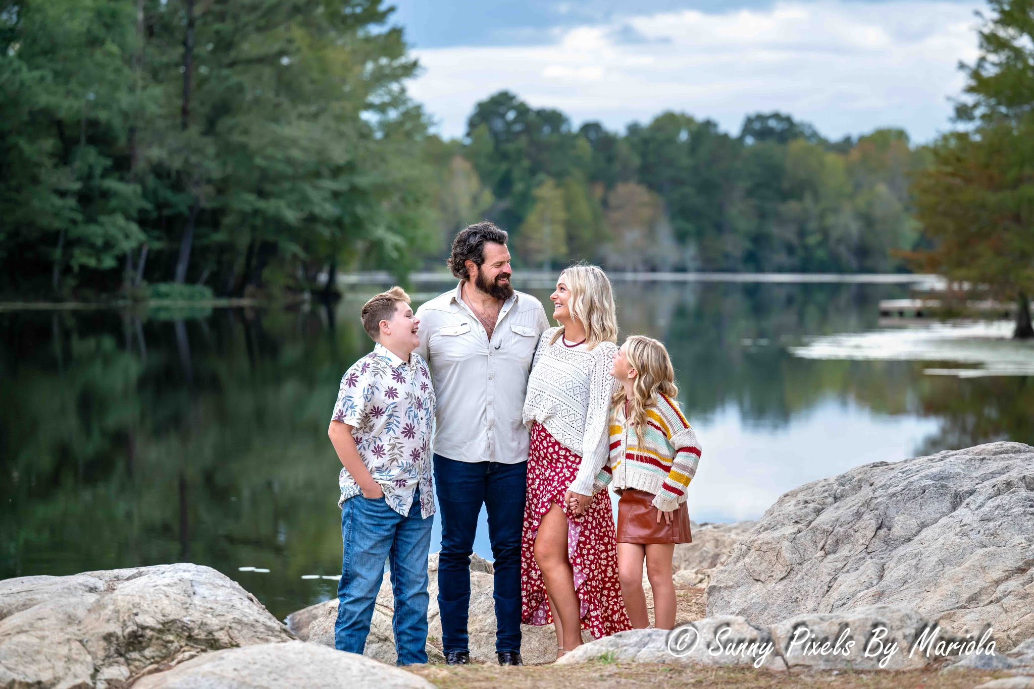 Beautiful sunlit family photography session during golden hour in a natural meadow