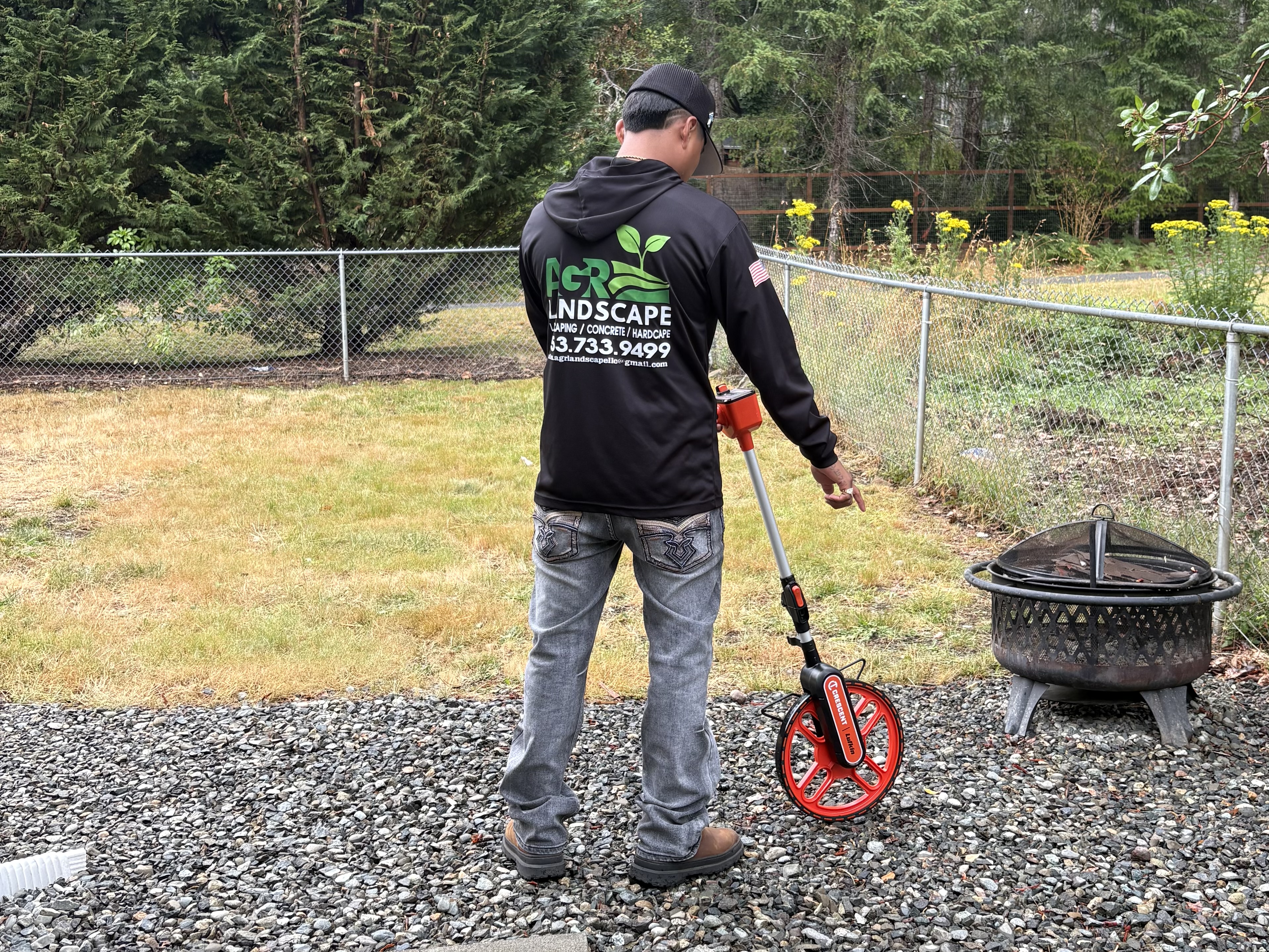 Professional portrait of AGR Landscape CEO smiling in landscaping work uniform