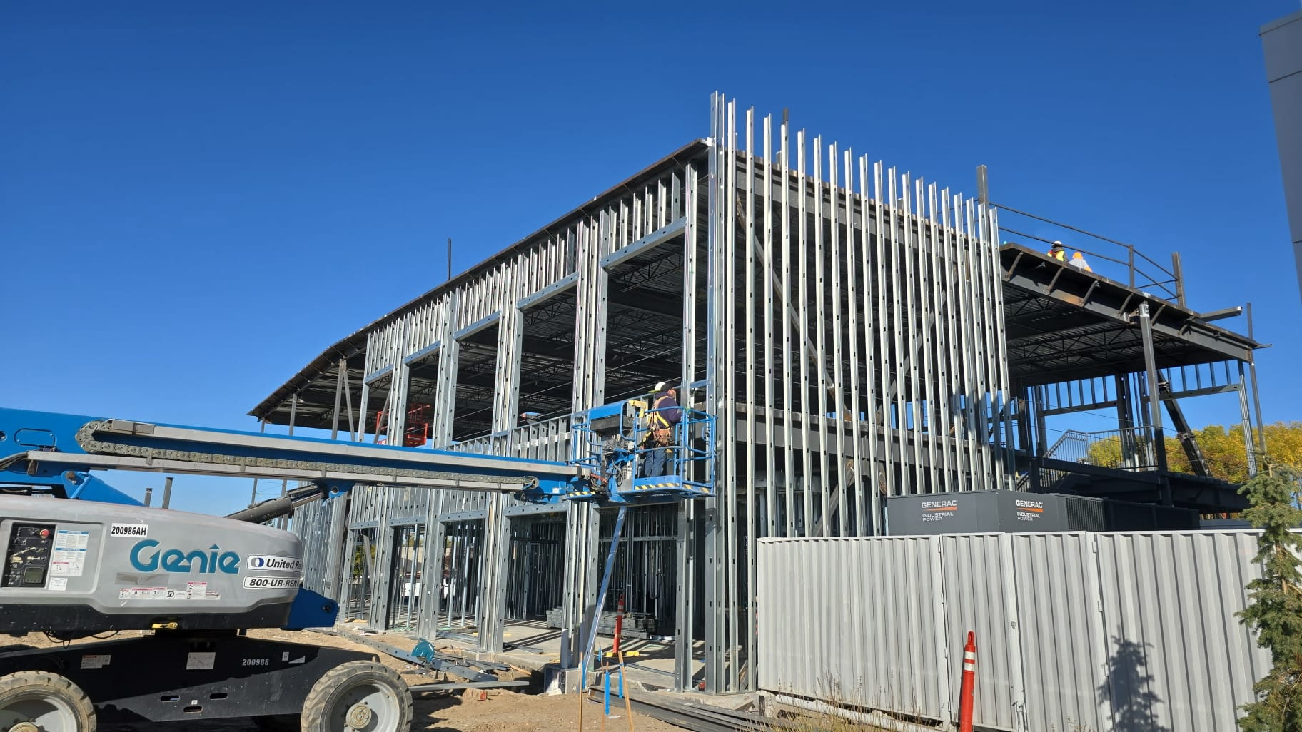 Commercial drywall and metal framing installation in progress at a large job site