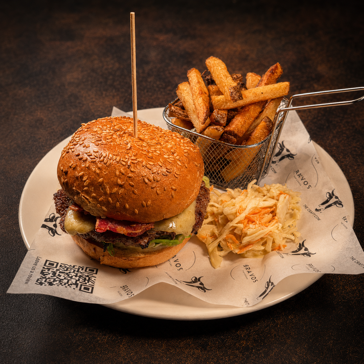 Gourmet stacked burger with melted cheese and brioche bun on rustic wooden board