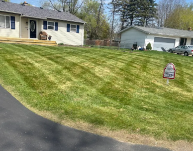 Perfectly manicured lush green lawn by Miracle Makers Lawn Service