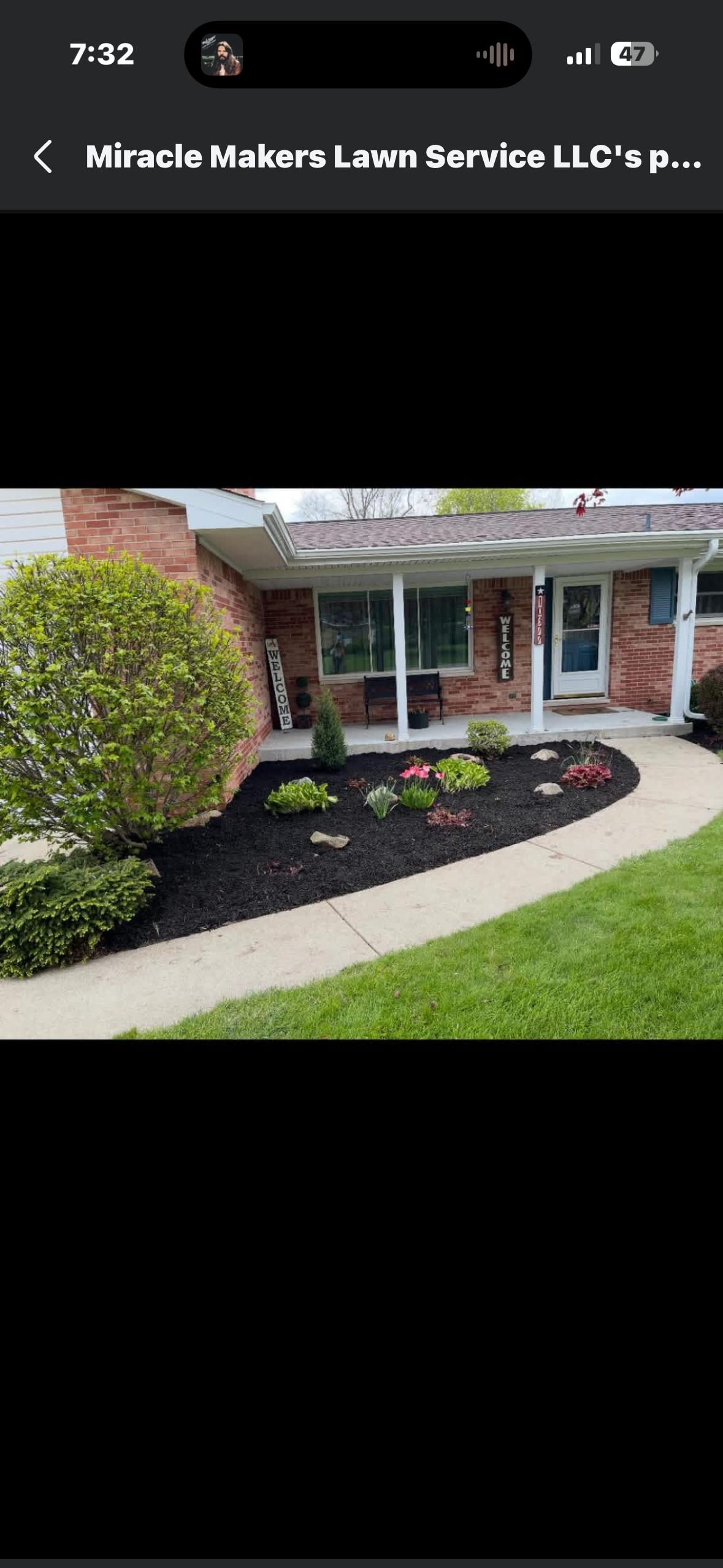Beautiful backyard landscaping project featuring fresh dark mulch and crisply edged garden beds