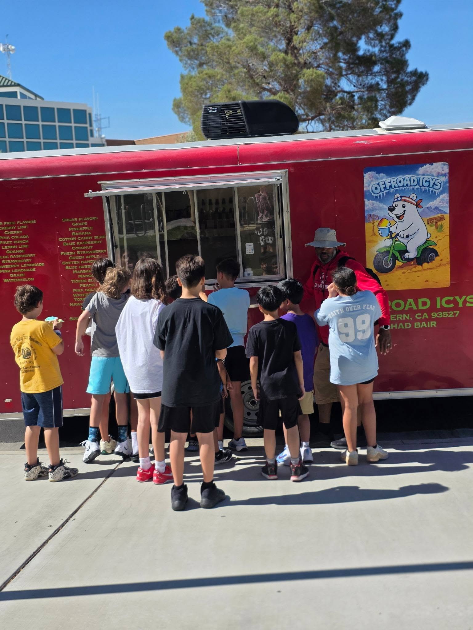 Custom offroad 4x4 dessert truck serving vibrant neon shaved ice in a rugged outdoor dirt landscape