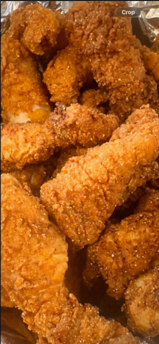 Crispy golden catfish nuggets served hot with dipping sauce and lemon wedges