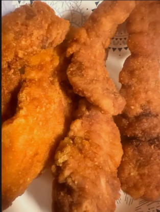 Hand-breaded golden fried chicken tenders piled high with dipping sauces