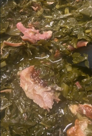 Southern-style slow-cooked collard greens in a rustic bowl, seasoned with smoky flavor